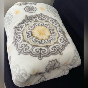 Life Comfort brand blanket or throw with a grey and yellow medallion pattern.